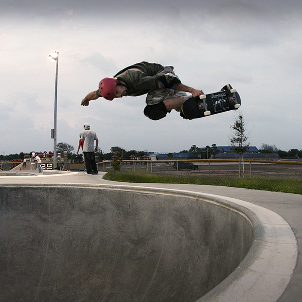 Photograph of skateboarder doing a backside air in the deep end of the bowl at the Cocoa Beach Skatepark. Photograph by Sebastian Aravena.